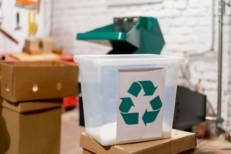 a plastic container with a recycle symbol on top of a cardboard box